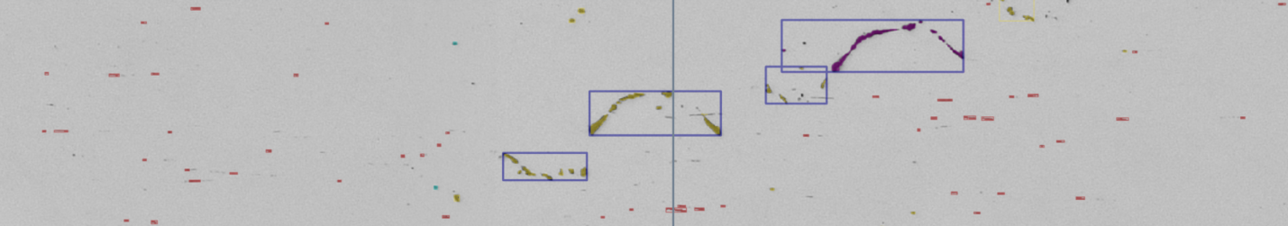 Gray field with vertical blue center line, violet boxes around arced yellow and purple areas and scattered red markers