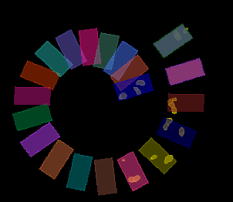 Two spiral arcs of multicolored rectangular tiles forming a circular gap, some tiles show small yellow marks on black.