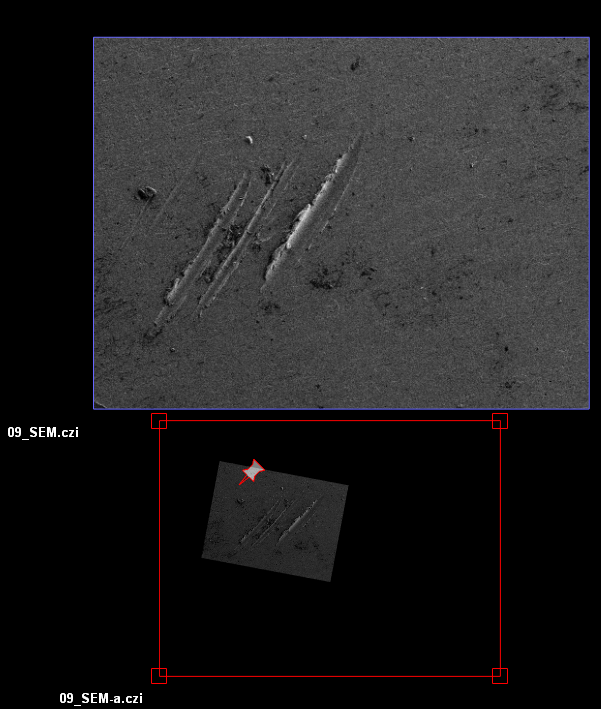 SEM interface with top grayscale image of parallel scratches and rotated lower image framed by red alignment box with pins