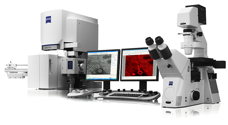 ZEISS microscope system with two monitors showing grayscale and red microscopic images, keyboard and control console
